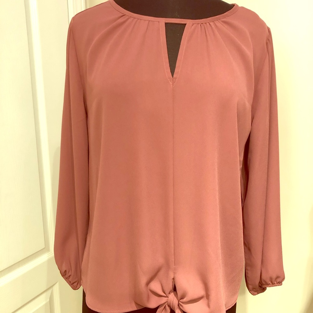 Blouse with tie at center bottom front